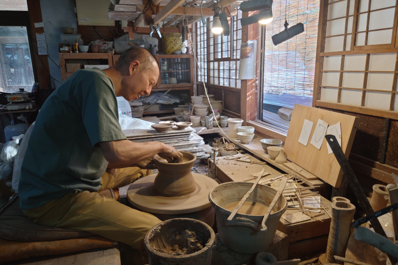 Potter at work at his pottery wheel 